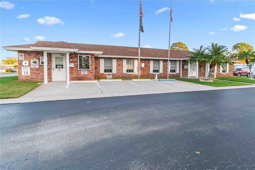 10399 67th Avenue North, Unit 4 St. Petersburg, FL 33708 - Photo 35 of 35 a front view of a house with a yard and potted plants
