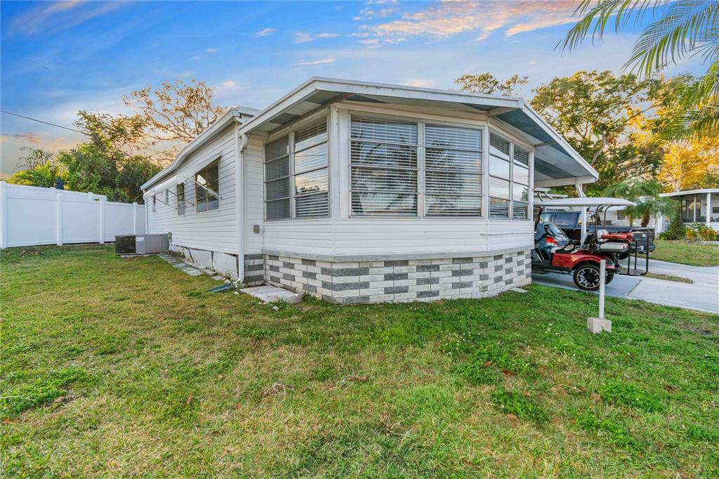 10399 67th Avenue North, Unit 4 St. Petersburg, FL 33708 - Photo 4 of 35 a view of a house with a yard and sitting area