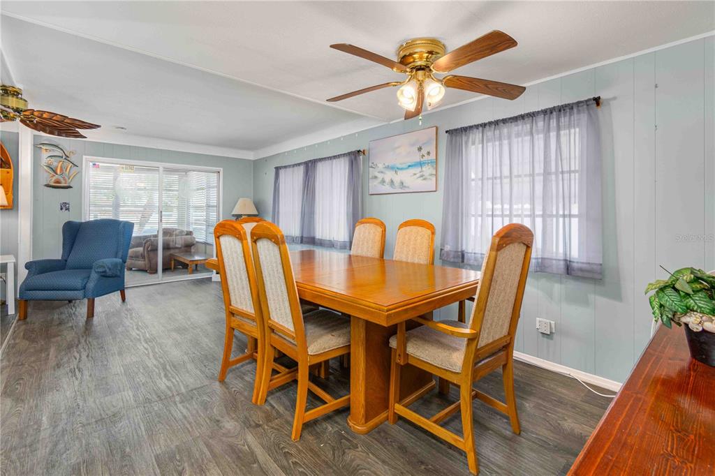 10399 67th Avenue North, Unit 4 St. Petersburg, FL 33708 - Photo 9 of 35 a view of a dining room with furniture and a chandelier