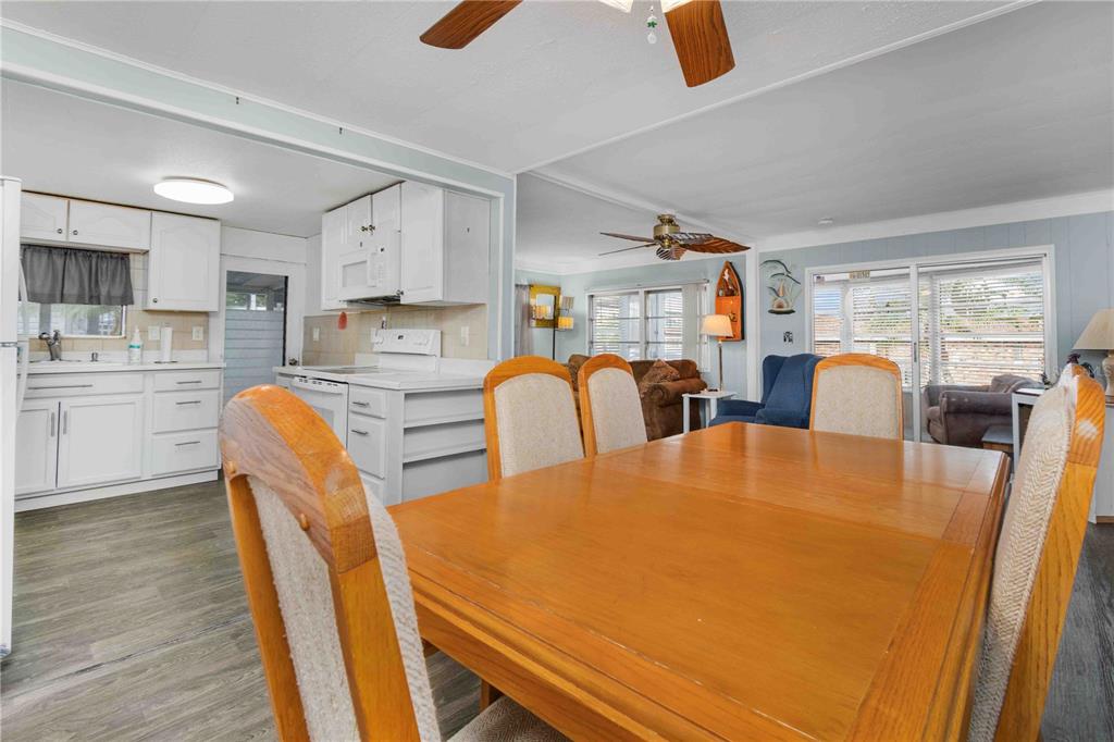 10399 67th Avenue North, Unit 4 St. Petersburg, FL 33708 - Photo 10 of 35 a dining room with stainless steel appliances furniture a window and kitchen view