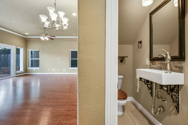 a bathroom with a sink a toilet a mirror and shower