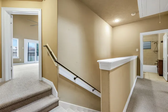 a view of hallway with stairs and wooden floor