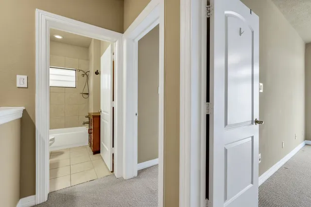 a view of a bathroom from a hallway
