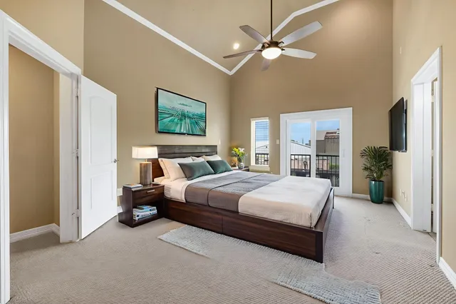 a bedroom with a bed couch and a window