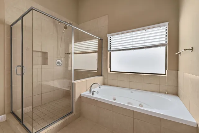 a bathroom with a bathtub and a shower