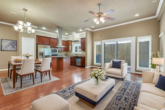 a living room with fireplace furniture and a chandelier