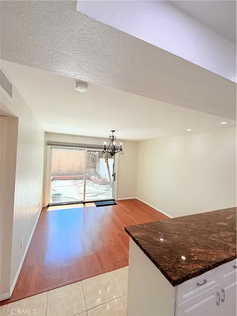 a view of a room with wooden floor and white walls