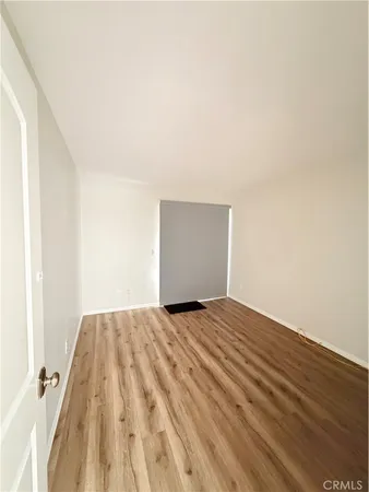 a view of a room with wooden floor and cabinet
