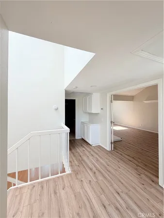 a view of wooden floor and windows in a room