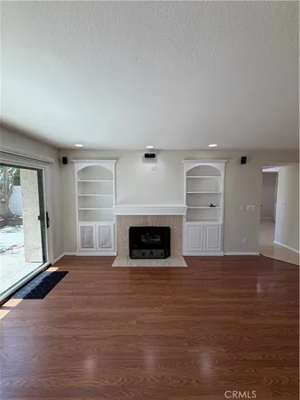 a view of a room with wooden floor