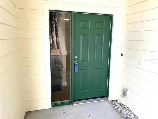 a bathroom with a green shower and a sink