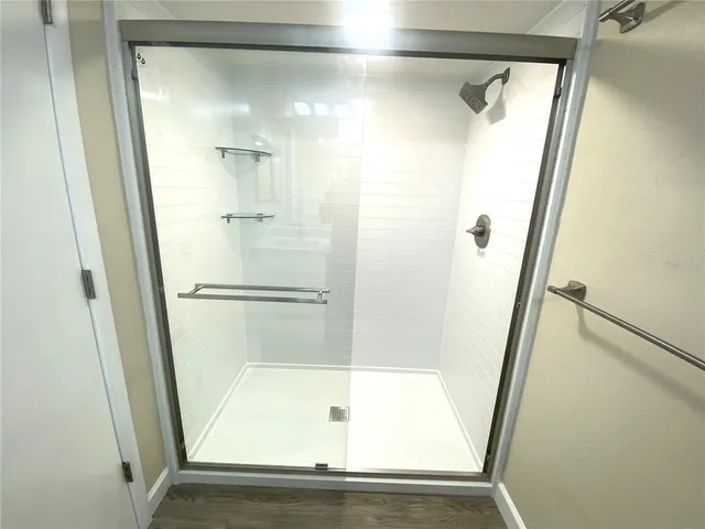 a bathroom with a sink a toilet a large mirror and vanity