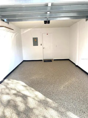 a view of a patio with a table and chairs under an umbrella
