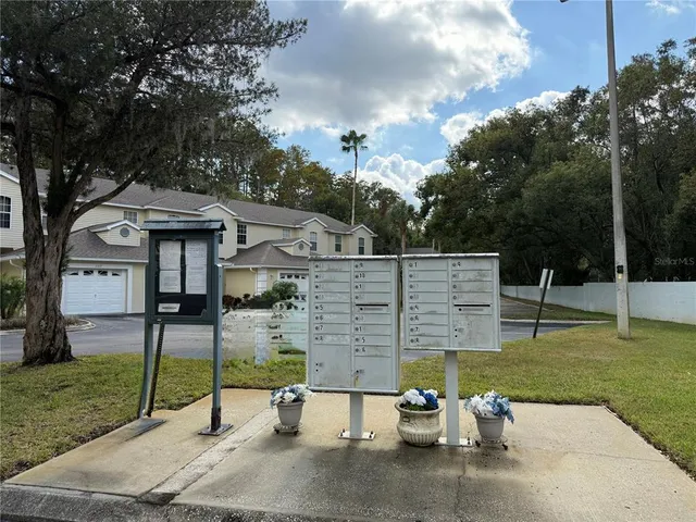 a view of a house with backyard and deck