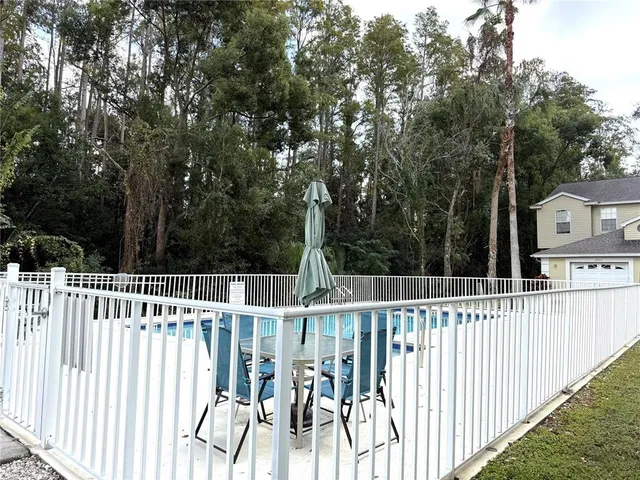 swimming pool view with wooden fencing