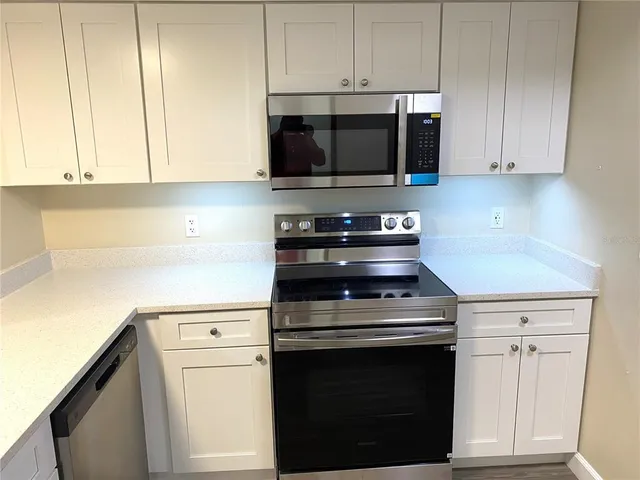 a kitchen with stainless steel appliances a refrigerator and a sink