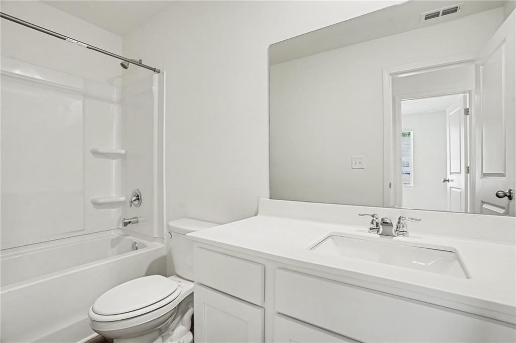 625 Jervis Way Locust Grove, GA 30248 - Photo 16 of 28 a bathroom with a sink a toilet and shower