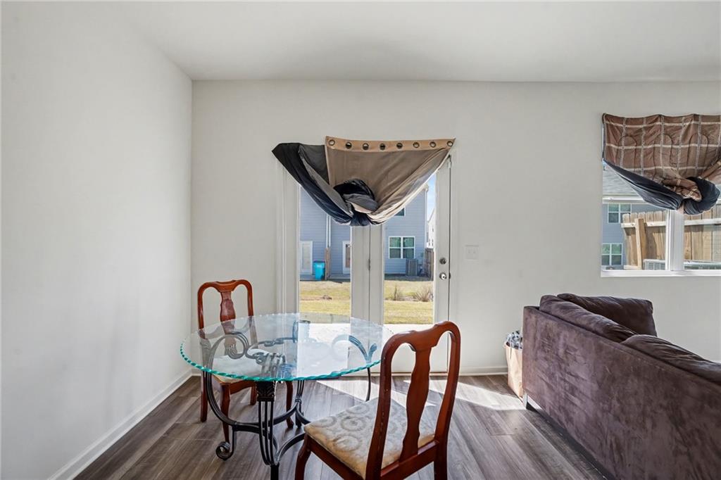 625 Jervis Way Locust Grove, GA 30248 - Photo 10 of 28 a view of a dining room with furniture and wooden floor
