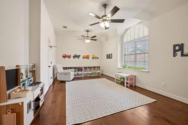 wooden floor with chandelier and window