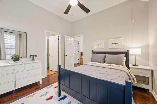 a large bedroom with a bed and a chandelier