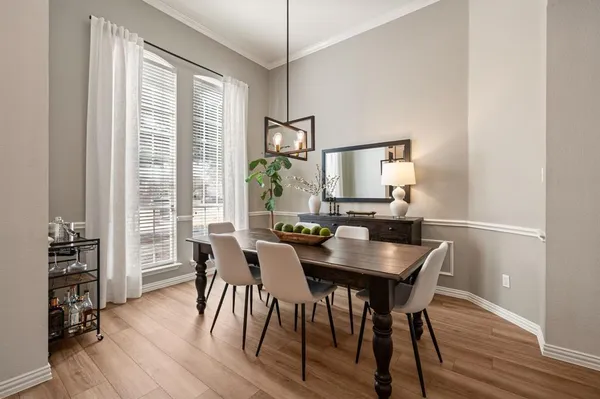 a view of a dining room with furniture window and wooden floor