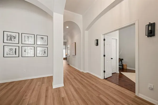 a view of a big room with wooden floor and windows