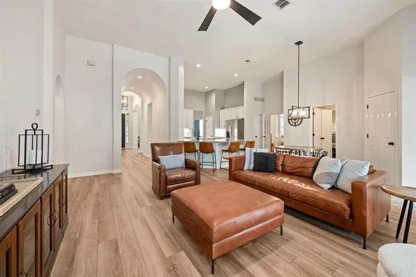 a living room with furniture and a wooden floor
