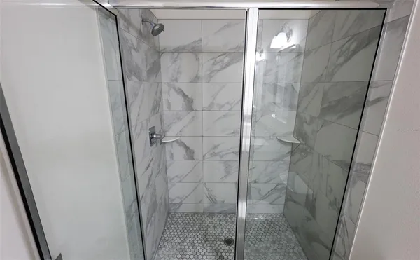 a bathroom with a glass door shower