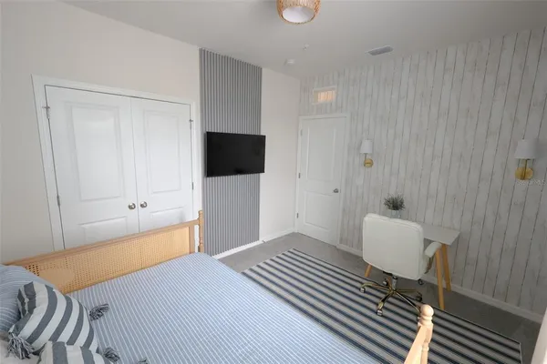 a bedroom with a bed and a television in it