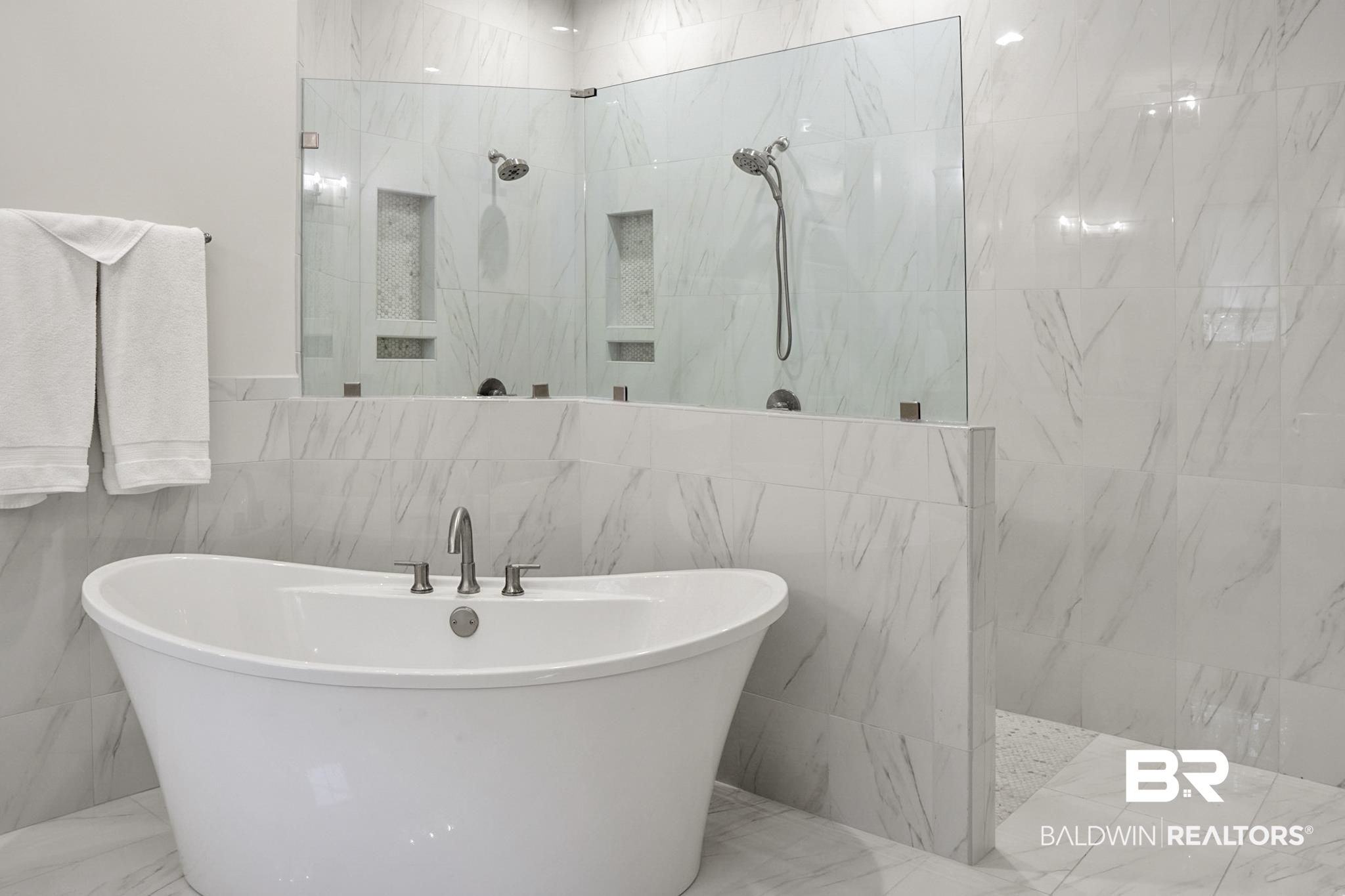 11258 Redfern Road Daphne, AL 36526 - Photo 27 of 44 Full bathroom with tile walls, a marble finish shower, marble tiled floors, and a freestanding bath