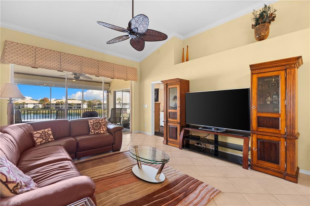 2255 Harmony Lane, Unit 204 Naples, FL 34109 - Photo 11 of 32 a living room with furniture and a flat screen tv