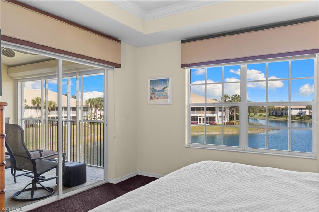 2255 Harmony Lane, Unit 204 Naples, FL 34109 - Photo 15 of 32 a bedroom with furniture and large window