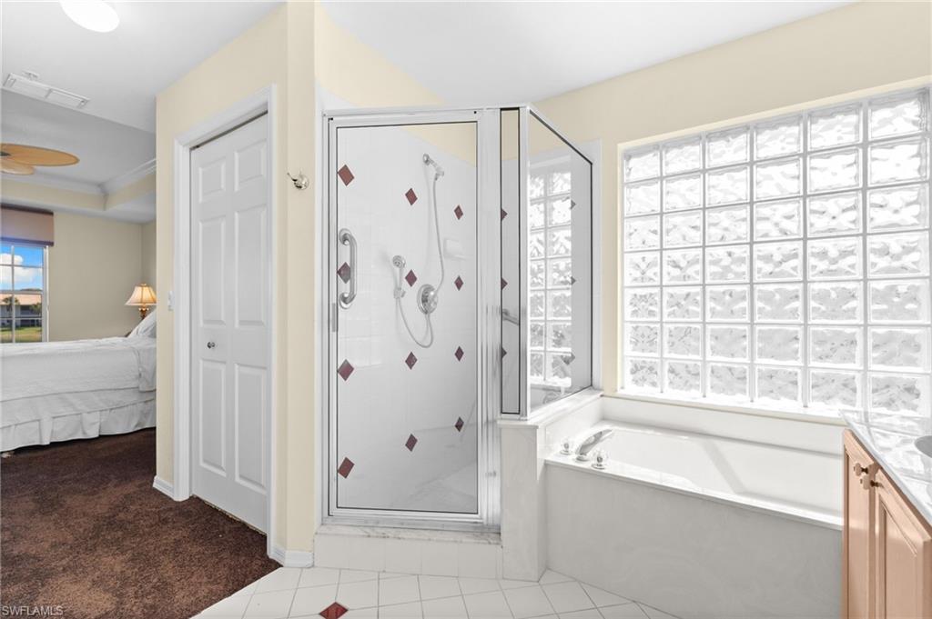 2255 Harmony Lane, Unit 204 Naples, FL 34109 - Photo 17 of 32 a spacious bathroom with a tub shower and sink