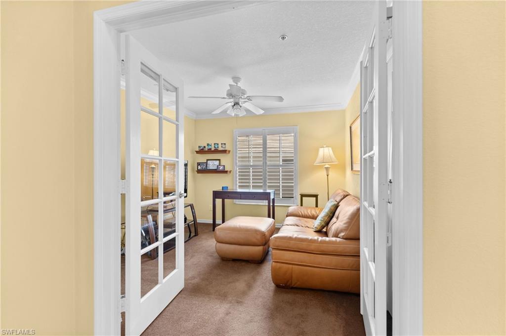 2255 Harmony Lane, Unit 204 Naples, FL 34109 - Photo 18 of 32 a living room with furniture and a large window