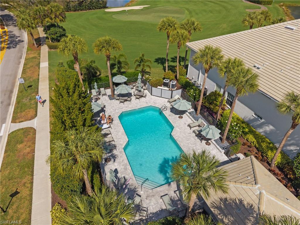 2255 Harmony Lane, Unit 204 Naples, FL 34109 - Photo 27 of 32 a view of a swimming pool with a patio
