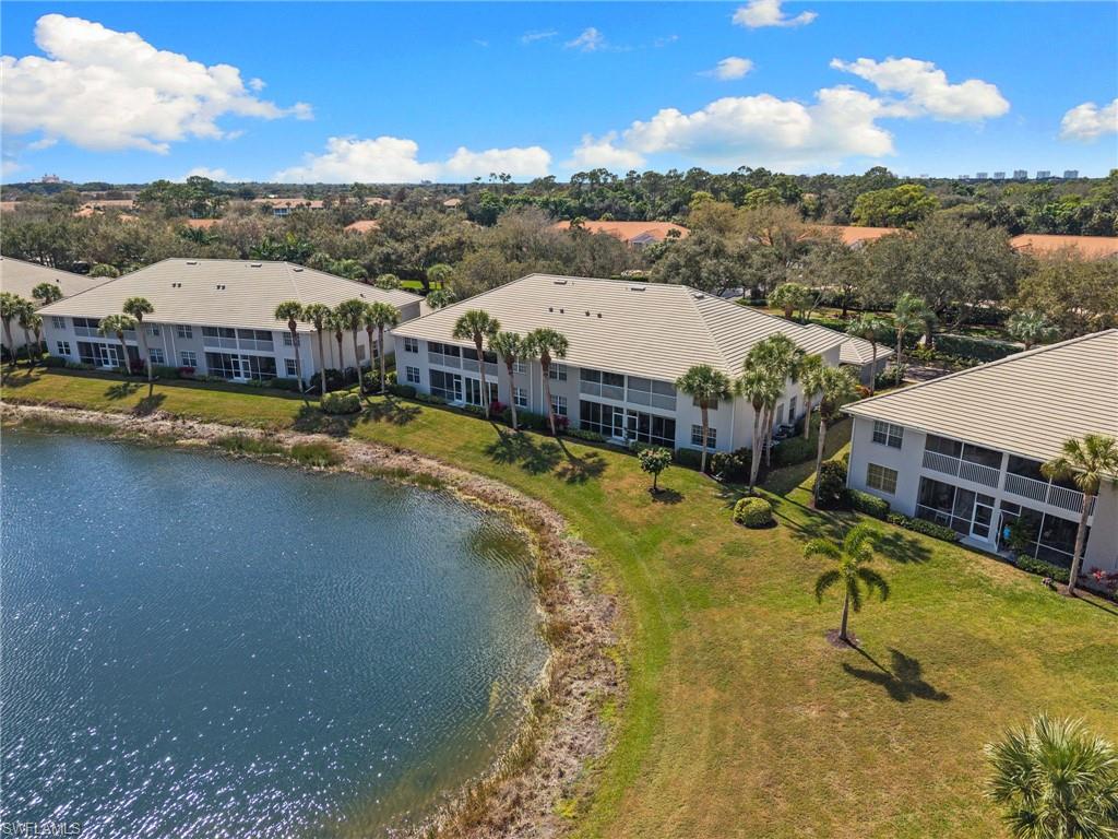 2255 Harmony Lane, Unit 204 Naples, FL 34109 - Photo 31 of 32 a view of a swimming pool with a lake view