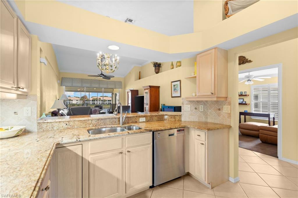 2255 Harmony Lane, Unit 204 Naples, FL 34109 - Photo 32 of 32 a kitchen with cabinets and window