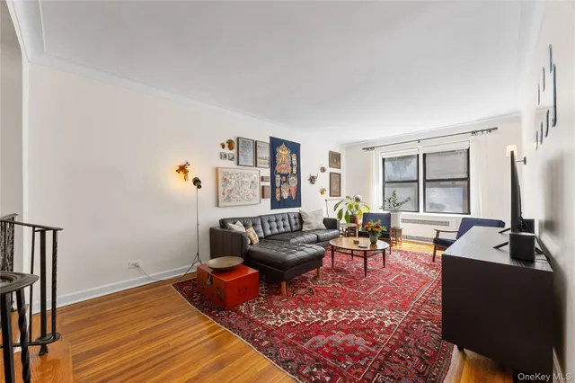 a living room with furniture a flat screen tv and a large window