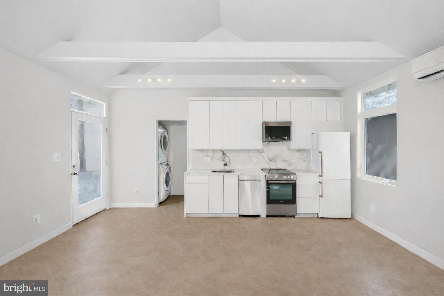 1209 Gallatin Street Northwest, Unit 2 Washington, DC 20011 - Photo 2 of 7 a view of a kitchen with a stove fridge and wooden floor