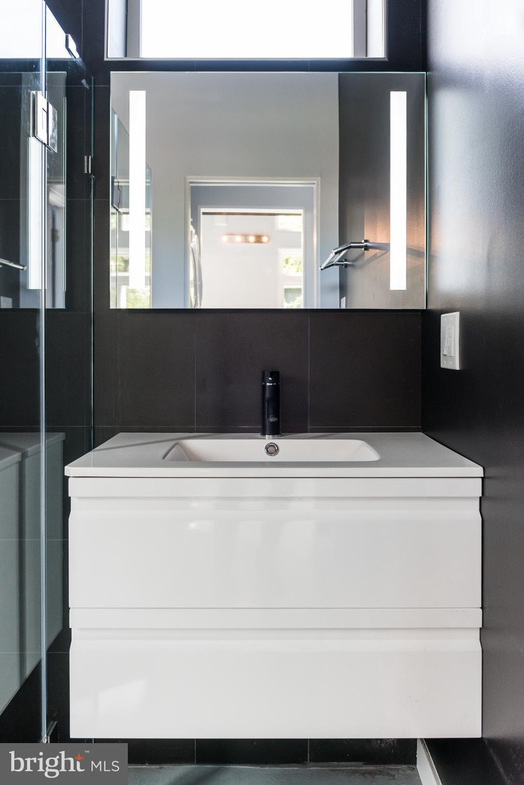 1209 Gallatin Street Northwest, Unit 2 Washington, DC 20011 - Photo 5 of 7 a bathroom with a sink mirror and vanity