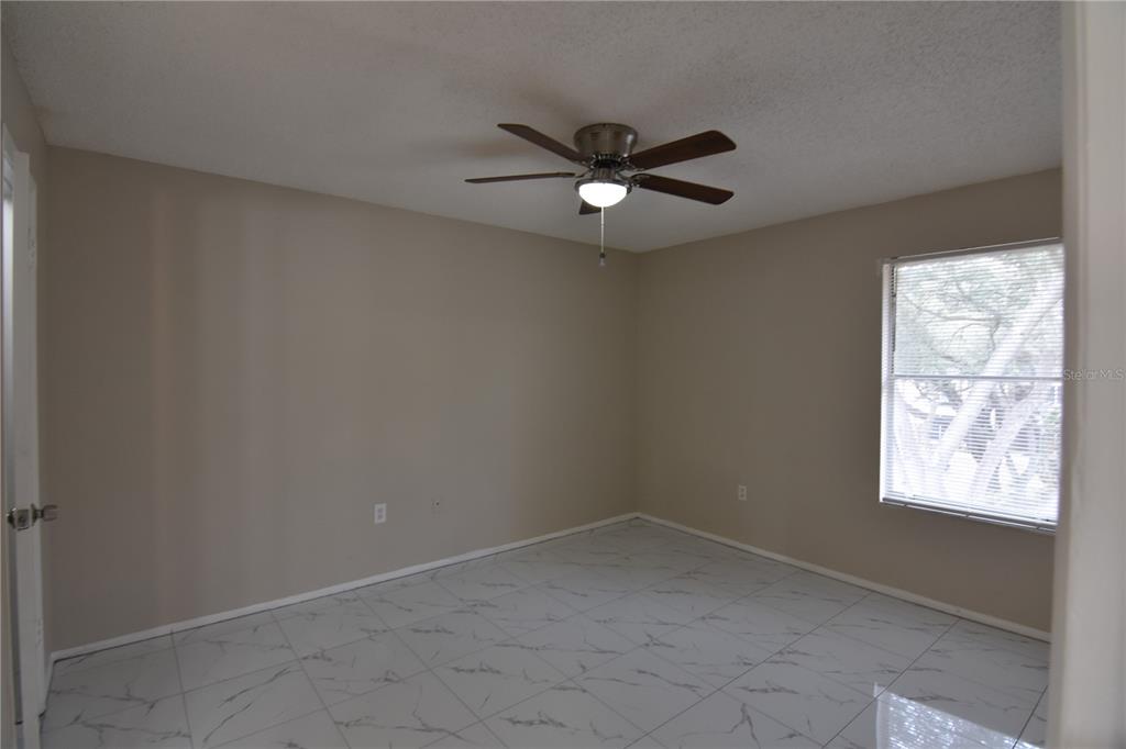 956 Salt Pond Place, Unit 303 Altamonte Springs, FL 32714 - Photo 13 of 17 an empty room with a window and a fan