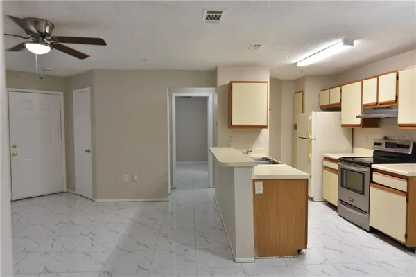 a kitchen with a stove a sink and a refrigerator