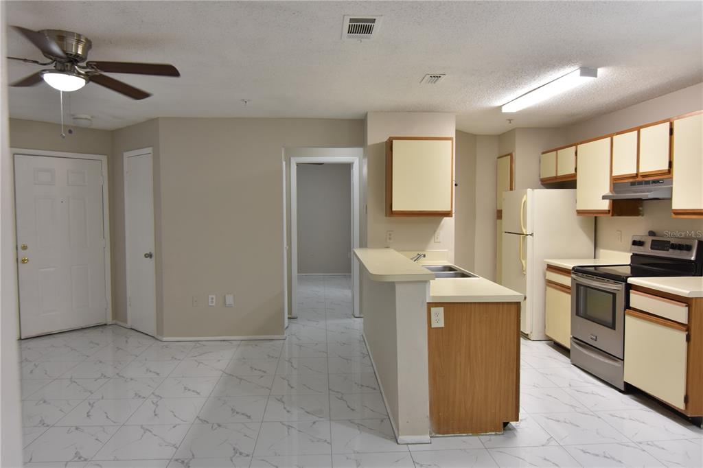 956 Salt Pond Place, Unit 303 Altamonte Springs, FL 32714 - Photo 3 of 17 a kitchen that has a sink a stove and a refrigerator