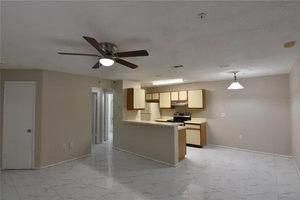 a view of kitchen with kitchen island wooden floor and window