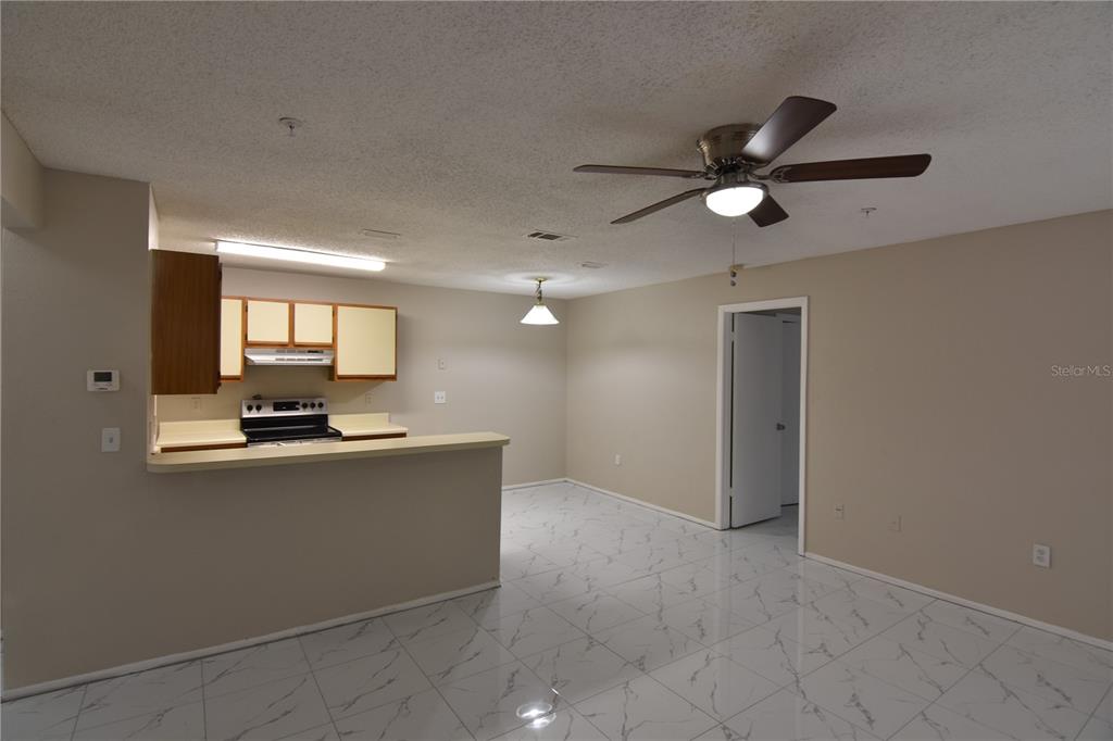 956 Salt Pond Place, Unit 303 Altamonte Springs, FL 32714 - Photo 5 of 17 a view of kitchen with kitchen island wooden floor and window