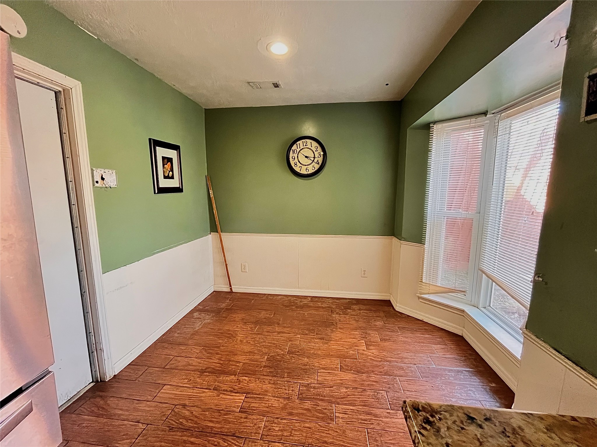 10403 White Clover Drive Houston, TX 77089 - Photo 3 of 11 a view of an empty room with wooden floor and a window