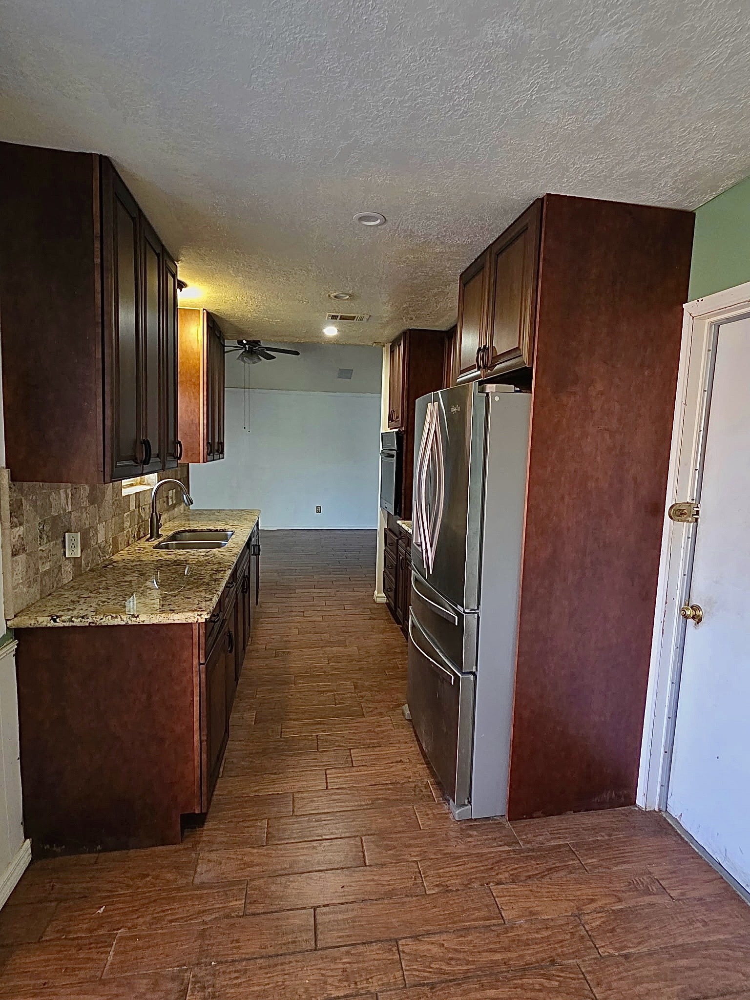 10403 White Clover Drive Houston, TX 77089 - Photo 4 of 11 a kitchen with stainless steel appliances granite countertop a refrigerator and a sink