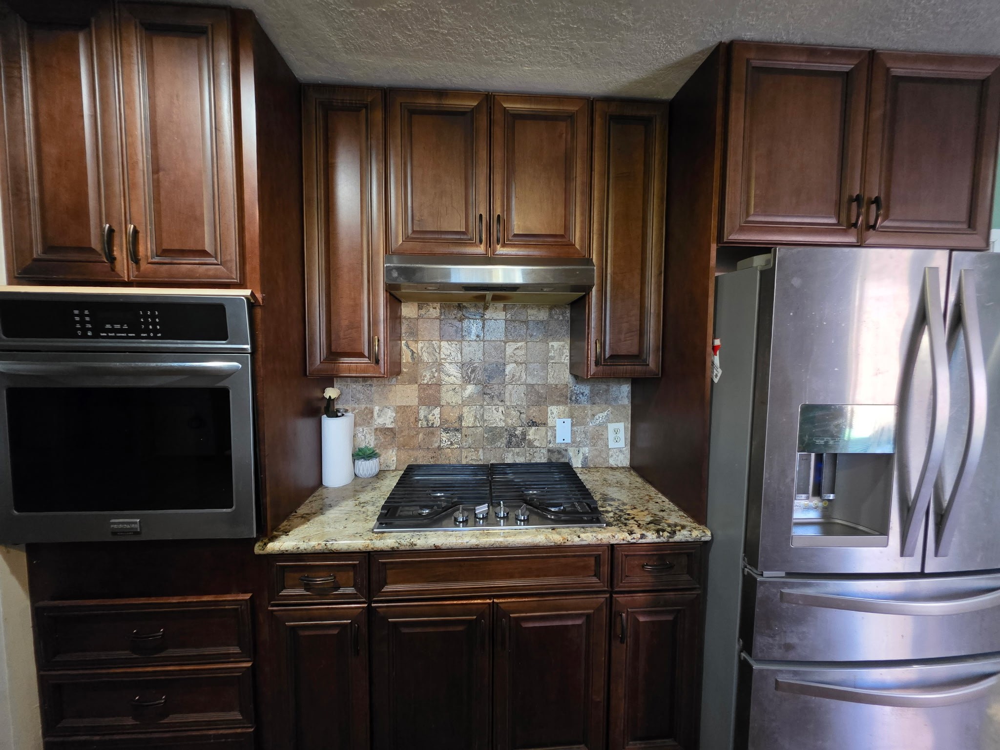 10403 White Clover Drive Houston, TX 77089 - Photo 6 of 11 a kitchen with granite countertop stainless steel appliances and wooden cabinets