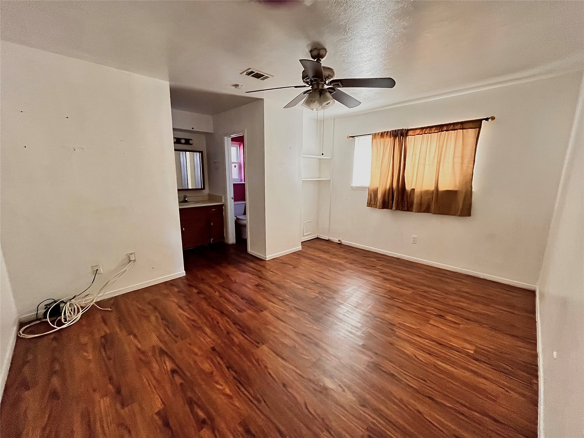 10403 White Clover Drive Houston, TX 77089 - Photo 10 of 11 a view of empty room with wooden floor and fan