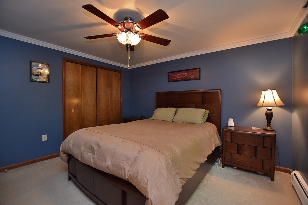211 Bumstead Road Monson, MA 01057 - Photo 11 of 30 a bedroom with a bed and a chandelier